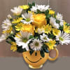 Yellow and white flower bouquet in a smiley-face mug