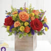 Mixed bouquet of roses, carnations, and button mums in a wooden box