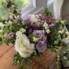 Lavender roses and white hydrangeas in a loose bouquet with berry branches