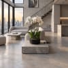 White orchid plant in a black pot on a marble table in a modern living room