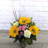 Bouquet of sunflowers, pink roses, and white carnations in a glass vase