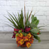 Autumn planter with mixed foliage and a sunflower ribbon bow in a low pot