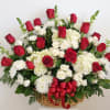 Basket arrangement of red and white roses with white chrysanthemums