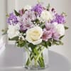 Bouquet of white and lavender flowers in a clear glass vase