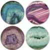 Set of four round coasters featuring colorful agate-inspired patterns in teal, purple, and pink.
