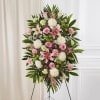 Standing floral spray with pink and white flowers on an easel