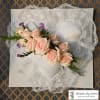 Lace heart-shaped pillow with a pale pink rose corsage