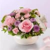 All-around arrangement with light pink roses and mini carnations, pink Limonium and