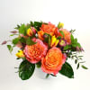 Orange and pink rose bouquet in a white vase