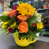 Mixed bouquet in a yellow smiley-face mug