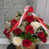 Basket arrangement of red and white roses with ribbon