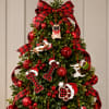 Decorated Christmas tree with red ornaments, plaid ribbon, and dog ornaments