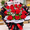Bouquet of red roses with a card reading I LOVE YOU