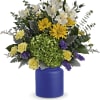 Bouquet of white, yellow, and purple flowers in a blue vase