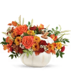 Orange and yellow floral arrangement in a white pumpkin vase