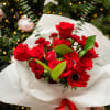 Bouquet of red roses and red anemones wrapped in white paper