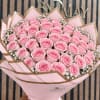 Bouquet of pink roses wrapped in pink and brown paper