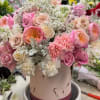 Pink and cream rose bouquet in a round hatbox