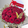 Red rose bouquet with leopard-print wrap and a Happy Birthday topper
