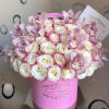 Pink and white roses with pale pink orchids in a pink box