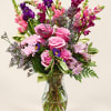 Pink and purple mixed bouquet in a clear glass vase