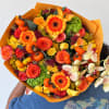 Bouquet of orange and yellow flowers with small pumpkins