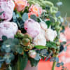 Pink and peach roses with pale peonies in a vase