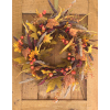 Autumn wreath with berries and mixed foliage on a wooden door