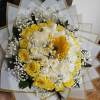 Bouquet of yellow and white roses with a sunflower and baby's breath