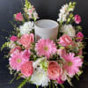 Pink and white floral wreath around a gray candle holder
