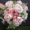 Pink rose bouquet with white filler flowers and greenery