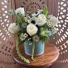 White roses and small daisies in a blue vase