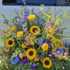 Sunflowers,delphinum,yellow roses,purple liatris and blue hydrangea are a beautiful celebration of life