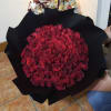 Large bouquet of red roses wrapped in black paper