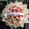 Large bouquet of pink and white roses with small white daisies