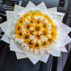 Bouquet of yellow sunflowers and white roses wrapped in white paper