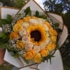 Bouquet of yellow and cream roses with a sunflower center