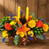 Orange and yellow floral centerpiece with two yellow candles