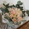 Bouquet of pale pink roses with white baby's breath and eucalyptus
