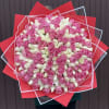 Large bouquet of pink and white roses wrapped in red paper