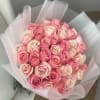 Bouquet of pink and blush roses wrapped in pale pink paper