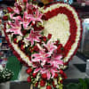 Heart-shaped floral spray with pink lilies and red roses
