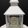 White memorial lantern with a sympathy quote and paw prints