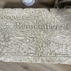 Rectangular memorial stone engraved with 'Forever Remembered' and a deer and mountain scene.