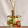 Glass reed diffuser with dried botanicals and cinnamon sticks