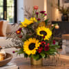 Sunflower arrangement in a gold vase with burgundy accents