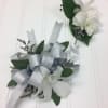 White Dendrobium Orchids accented with light blue delphinium makes this the perfect