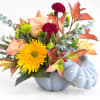 Fall bouquet in a blue pumpkin-shaped vase with roses and chrysanthemums