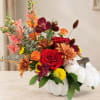 Mixed floral arrangement in a white pumpkin container