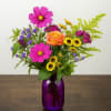 A colored mason jar with mix of fall farm blooms!